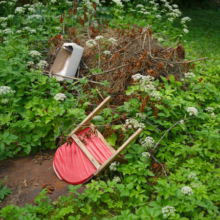 Discarded children chair abandoned on a garbage heap in the backyard