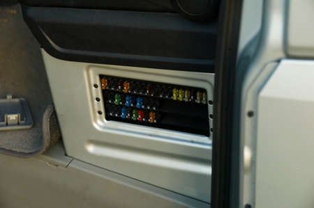 Close up shot of a car fuse box with removed cap
