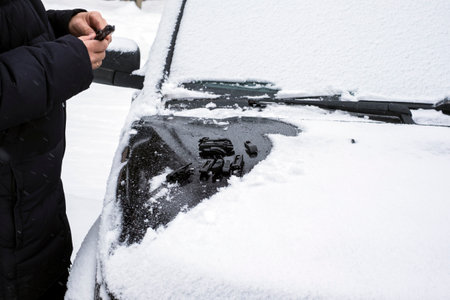 Windshield broken wiper blades replacement, focus in the foregroud, winter scene