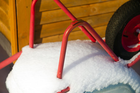 A turned over trolley and covered with snow, sunny day closeupの写真素材