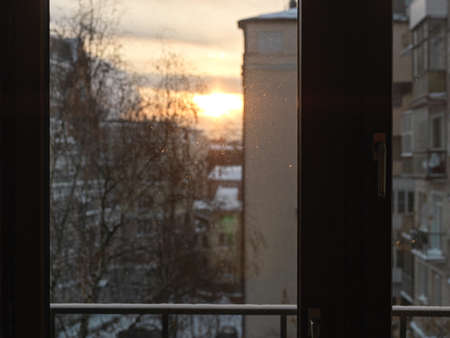 Sunrise in the city through a dusty window, winter sceneの写真素材