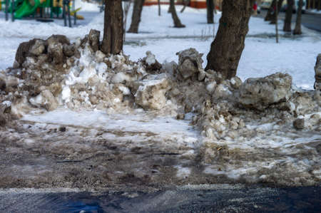 Dirty melting snowdrifts in springtime, urban sceneの写真素材