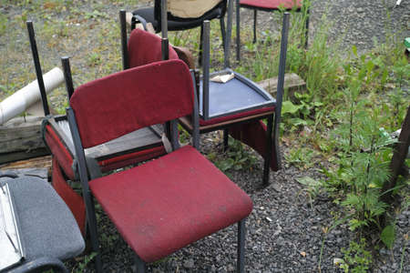 Collection of discarded old office chairs, outdoor shot without peopleの写真素材