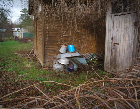 A backyard with overturned old basins and buckets, daylight sceneの写真素材