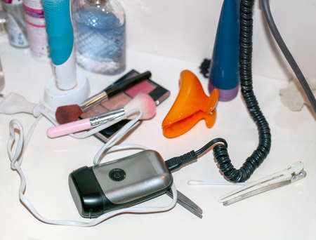 collection of personal toiletries on a messy table, indoor still life