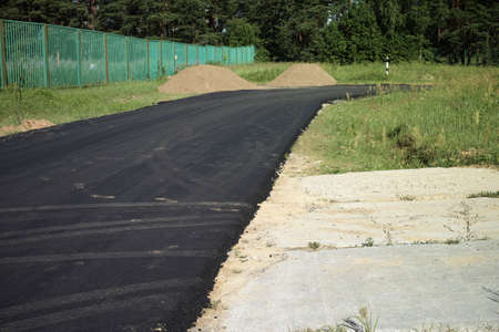 a landscape with a brand new asphalt road, sunny day shotの写真素材