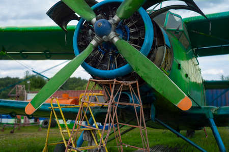 Service of an old aircraft engine on the airfield workshop, outdoor shotの写真素材