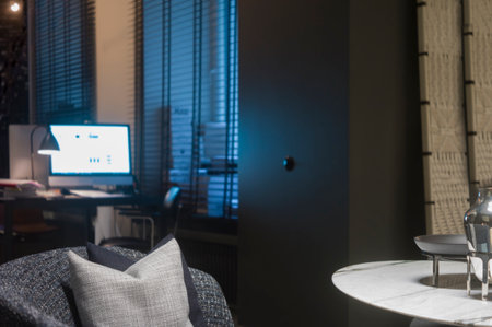 a modern room with a sofa in the foreground and computer in the blurred backgroundの写真素材