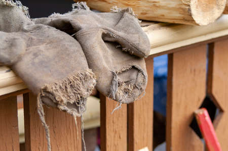 Torn construction or gardening mittens, outdoor close up shotの写真素材