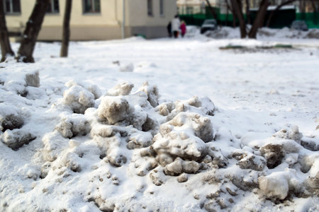 dirty melting snowdrifts on the street, urban scene