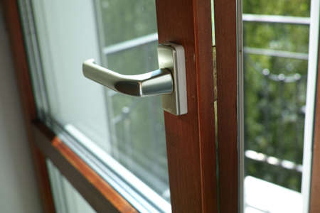 a loosely closed balcony door and a gap left, indoor closeupの写真素材