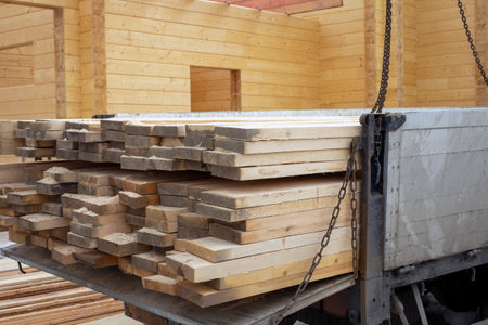a trailer loaded with planks for unfinished wooden house, outdoor shotの写真素材
