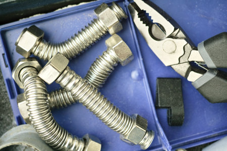 closeup of a blue box with pliers and flexible water hoses