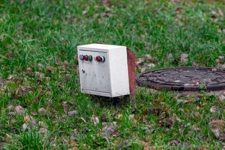 fuse box and manhole cover, outdoor shot without people