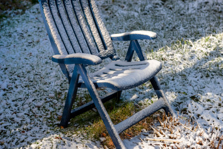 a garden folding chair abandoned outdoor, winter sceneryの写真素材
