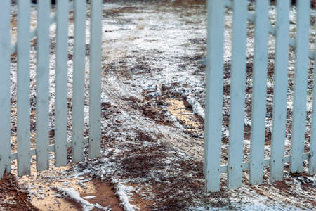 frozen ground and open gate, a tilt shift outdoor shotの写真素材