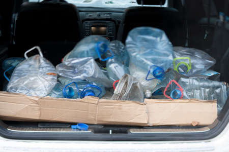 A car trunk loaded with old plastic bottles, tilt shift focusの写真素材
