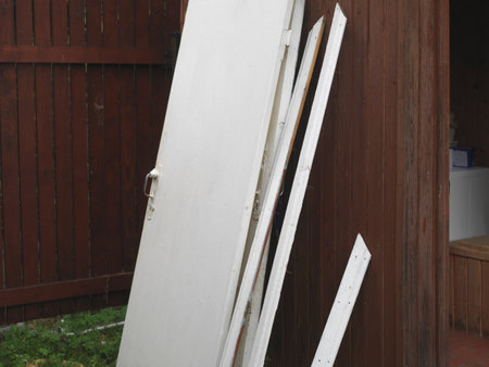 Old discarded wooden door leaning against the wall, outdoor shotの写真素材
