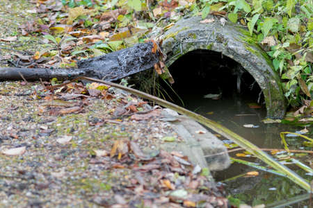 a pipe and trench dirt removal with spade, outdoor closeupの写真素材
