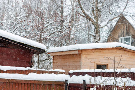 rooftops of wooden houses during a heavy snowfall, winter sceneryの写真素材