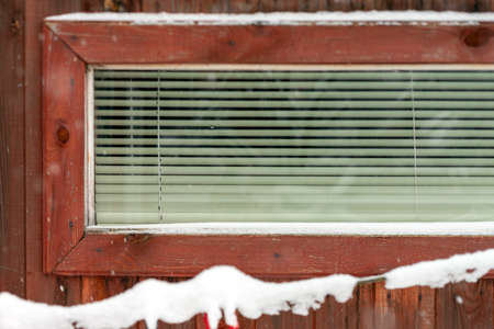 tilt shift image of a window with shut blinds, winter sceneの写真素材