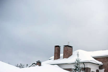 landscape with a modern building rooftop with chimneys, winter sceneの写真素材