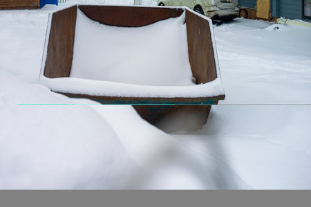 a garbage container full of snow in the backyard, winter sceneの写真素材