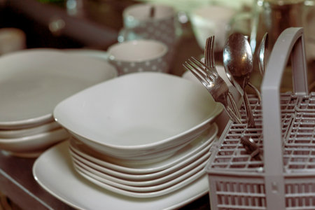 sorting clean dishes after wash, indoor filtered imageの写真素材