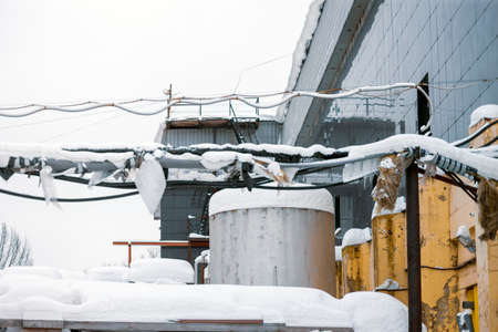 a tank and heat pipeline covered with snow, outdoor winter shotの写真素材