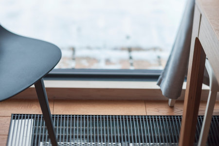 interior of a room with floor heating and the snow behind the window, shallow dofの写真素材