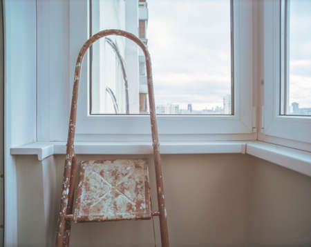 a stepladder abandoned on a balcony after renovation, daylight shotの写真素材