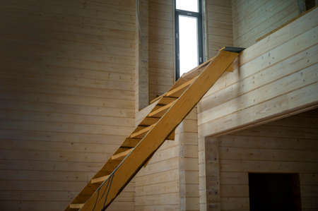 a temporary arranged ladder from a ground to first floor in unfinished houseの写真素材