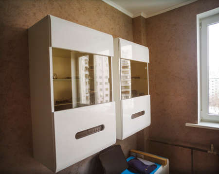interior of a modern room with white cabinets mounted on the wallの写真素材