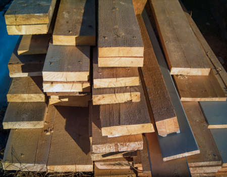 outdoor stack of cut wooden boards, sunny daylight shotの写真素材