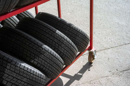 a stand with brand new tires for sale, outdoor shot