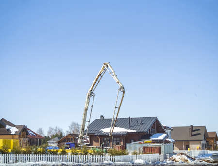 a working crane in town, winter daylight shotの写真素材