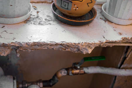 closeup of a damaged windowsill and heating pipes, indoor shotの写真素材