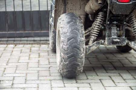 dirty bald tires of four-wheel-drive atv, outdoor cropped shotの写真素材