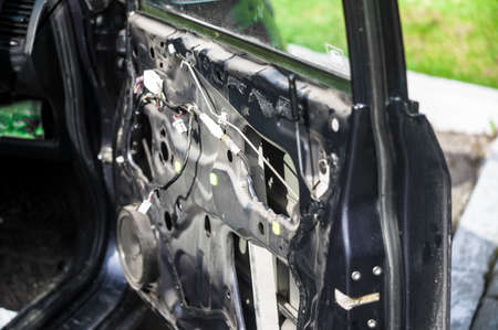 outdoor shot of a car with partly disassembled open doorの写真素材