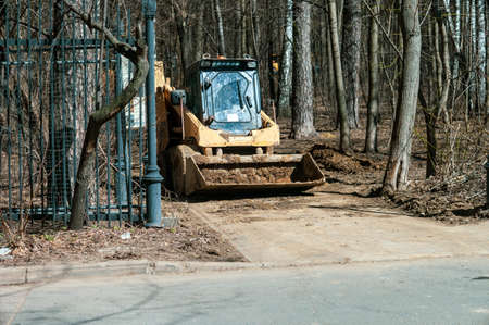 a bulldozer and excavation works in a park, sunny day shotの写真素材