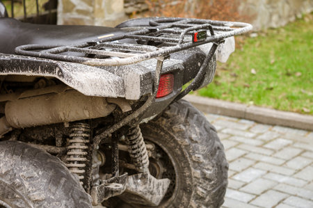 Dirty wheels and suspension of ATV, outdoor daylight shotの写真素材