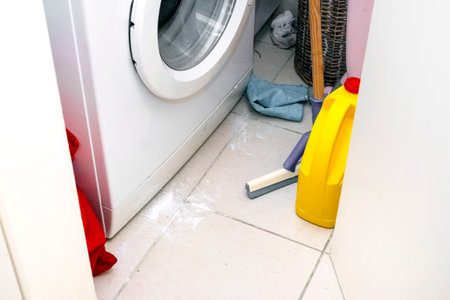 messy bathroom with spilled washing powder on the floorの写真素材