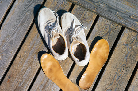 a pair of sneakers and insoles drying on the sun, outdoor shotの写真素材