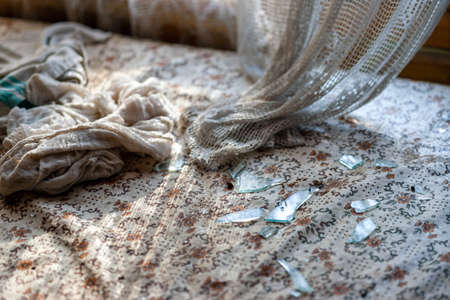 closeup of a table covered with broken glass, indoor shotの写真素材