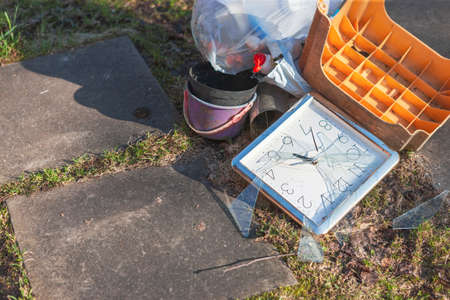 A pile of garbage and broken clock in the center of composition, outdoor shotの写真素材