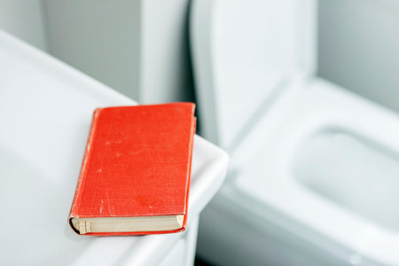 a book in red cover left in a toilet, extremely shallow DOFの写真素材