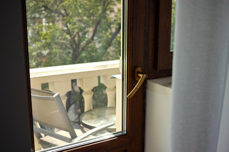 closeup of a shut balcony door and curtain in a summertime dayの写真素材