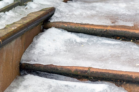 winter daytime outdoor shot of slippery stone steps covered with iceの写真素材