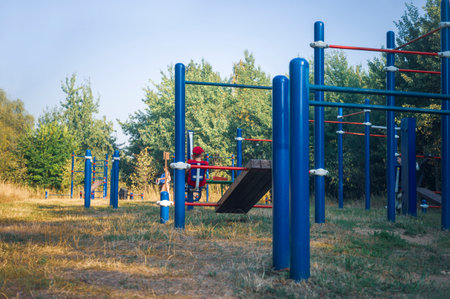 outdoor sport ground and a boy sitting in the background, summertime outdoor shotの写真素材