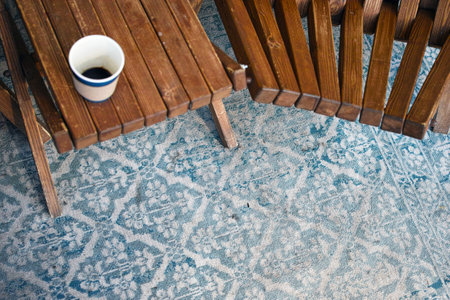 a group of wooden armchairs placed on old carpet, outdoor shotの写真素材